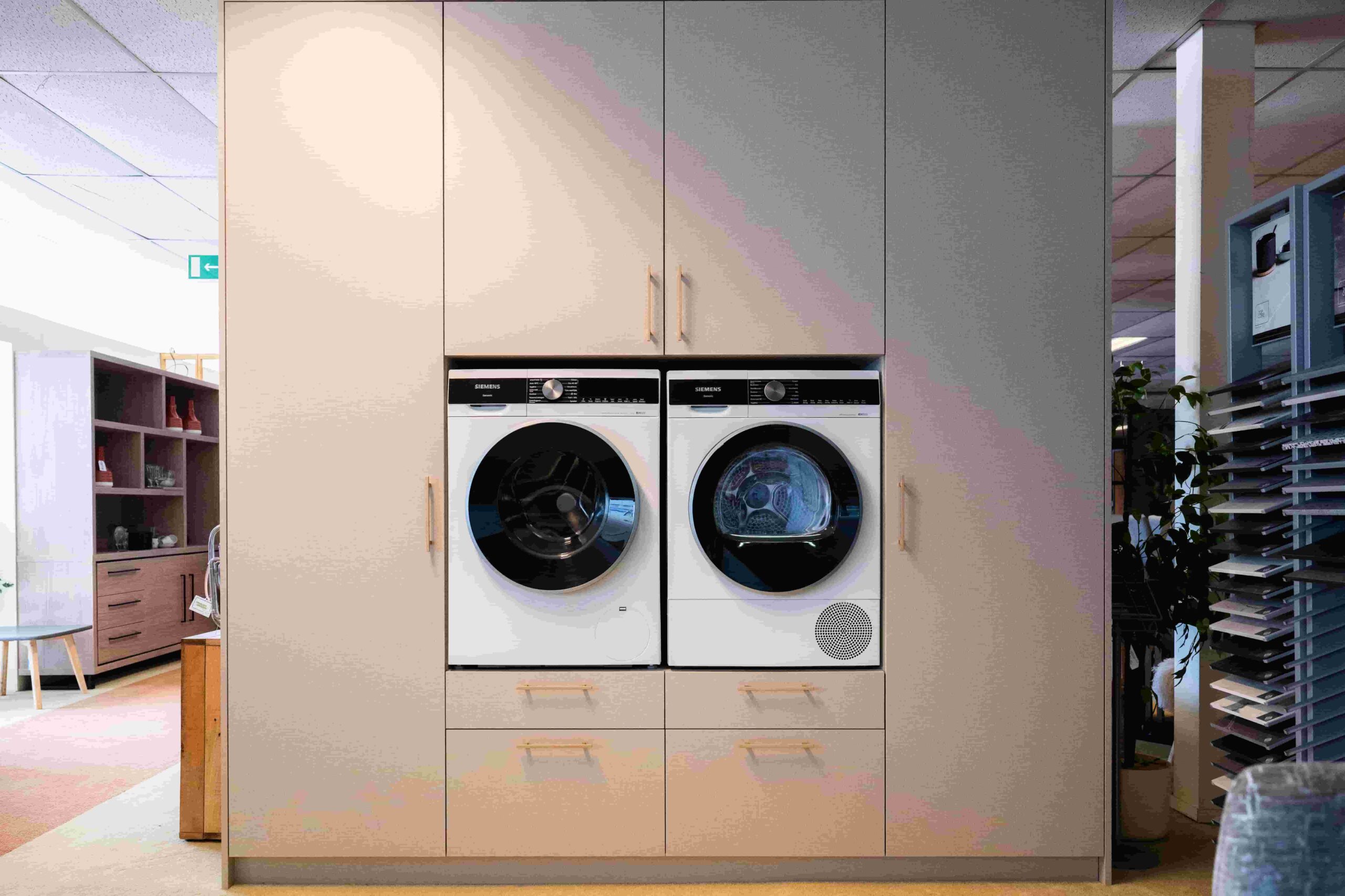 Ruime bijkeukenkasten met ruimte voor droger en wasmachine. Volledig op maat gemaakt zodat alle ruimte maximaal benut wordt.